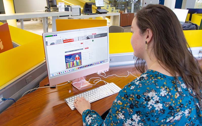 student working on a library computer