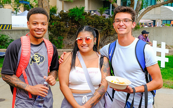 three students smiling for the camera