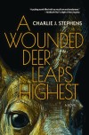 Book cover of "A Wounded Deer Leaps Highest" by Charlie J. Stephens. Features a close-up of a deer's eye, textured with dark, warm tones. The mood is intense and captivating.