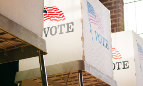 voting box adorned in American flag with text Vote