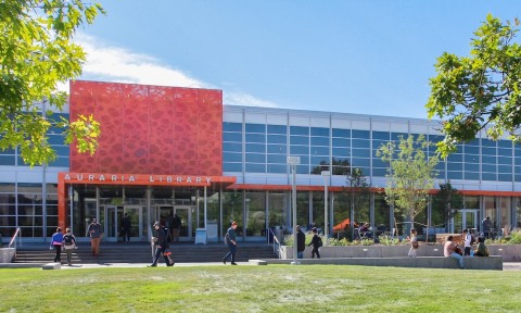 The front view of a building featuring a prominent large orange sign, showcasing its vibrant and eye-catching design.