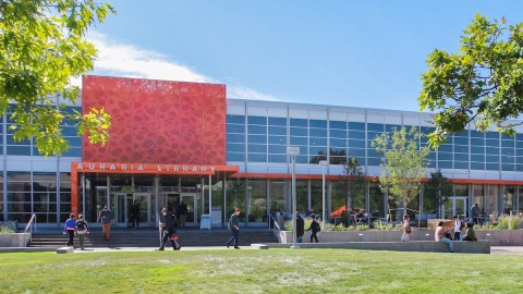 The front view of a building featuring a prominent large orange sign, showcasing its vibrant and eye-catching design.