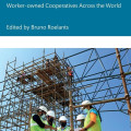 Cover of "Cooperativism at Work" by Bruno Roelants. Features construction workers in hard hats and vests reviewing plans, amidst scaffolding.