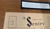 Vintage October 1964 issue of *The Sentry*, a University of Colorado Denver student newspaper, lies on a wooden table; a placard describes its historic origin.